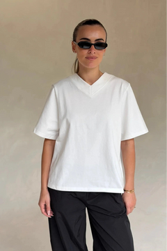 White Olivia High V Neck Relaxed Tee with short sleeves and a loose fit on a plain background.