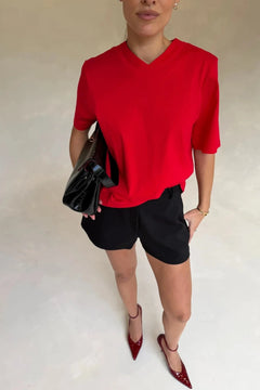 Red Olivia High V Neck Relaxed Tee with short sleeves and a loose fit on a plain background.