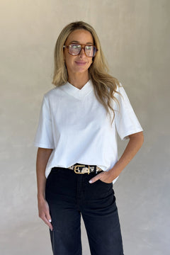 White Olivia High V Neck Relaxed Tee with short sleeves and a loose fit on a plain background.
