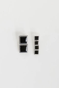 Archer Drop Earrings in Silver – mismatched silver PVD-plated earrings with black enamel drops, perfect for sleek day-to-night styling.