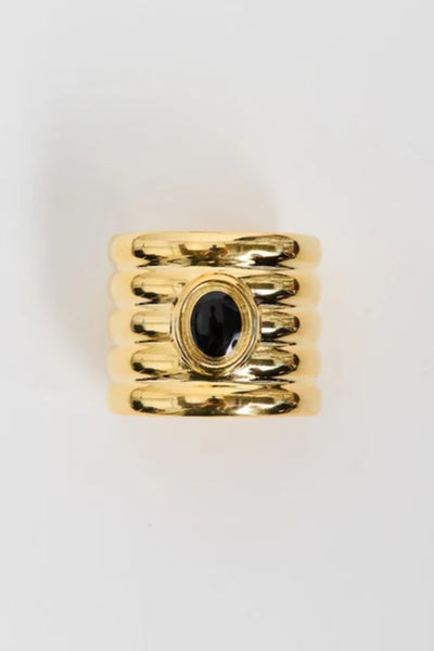 Clarke Cuff by Heaven Mayhem – a gold sculptural cuff with ridged detailing and a black enamel center, perfect for bold refined styling.