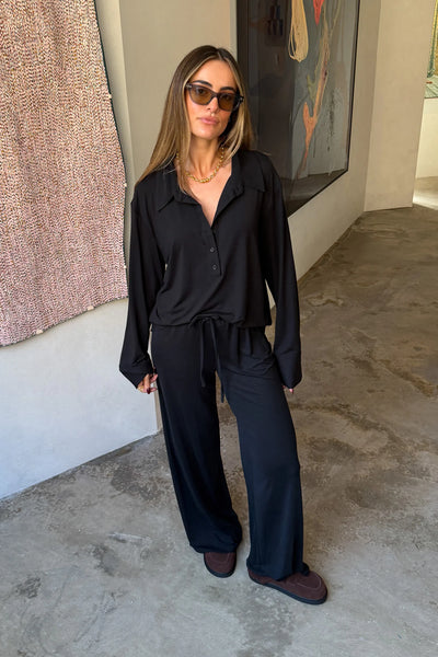 The Hunter Long Sleeve Polo Top in Black by Sneaky Link is a soft second skin essential with a flattering fit, polished collar, and easy everyday appeal.