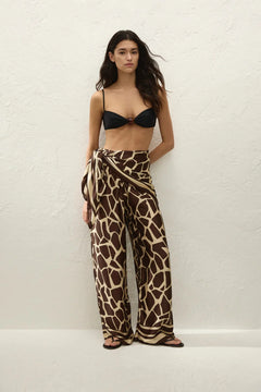 Jensen Pant in Ombra by Faithfull the Brand, a mid-rise satin pant with elasticated waist, wide straight leg, and animal print finish.