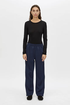 Locus Scuba Pant in Midnight by Camilla and Marc, a mid-rise scuba pant with side stripe detailing, pintuck legs, and zip hem finish.