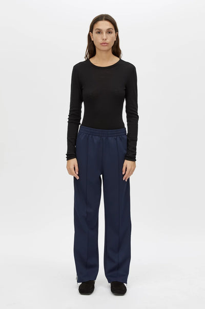 Locus Scuba Pant in Midnight by Camilla and Marc, a mid-rise scuba pant with side stripe detailing, pintuck legs, and zip hem finish.