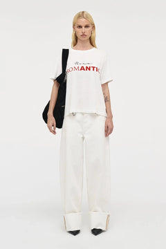 Nancy Barrel – White by Neuw Denim, mid-rise barrel leg jeans with cuffed hem and stretch comfort. Perfect for modern denim styling.
