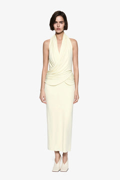 The Cabana Cupro Dress by MISHA, a lemon midi with halter neckline and soft hip drape. Perfect for weddings or refined summer events.
