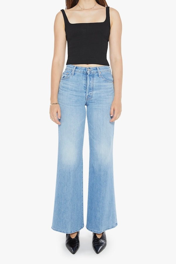 The Tomcat Roller Skimp Puzzled by MOTHER, trendy high-waisted wide-leg jeans with a button fly and light blue wash. Perfect for a relaxed, stylish look with whiskering and fading at the knees.