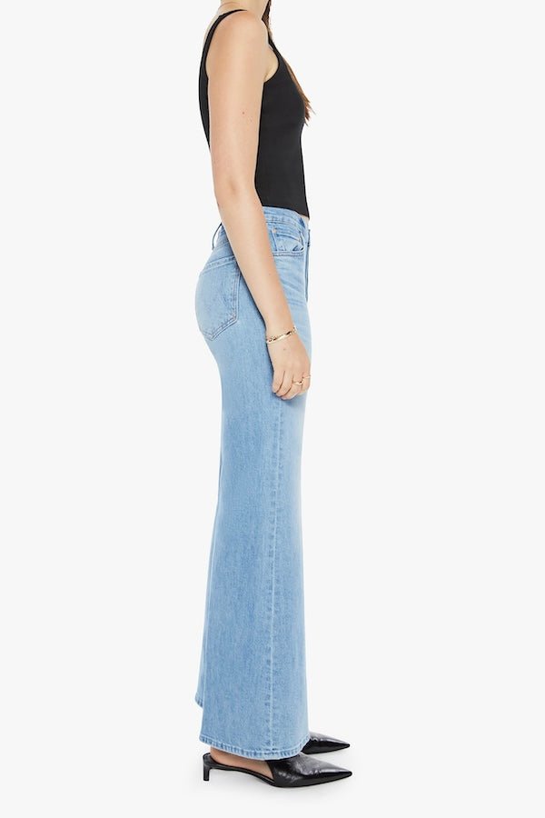 The Tomcat Roller Skimp Puzzled by MOTHER, trendy high-waisted wide-leg jeans with a button fly and light blue wash. Perfect for a relaxed, stylish look with whiskering and fading at the knees.