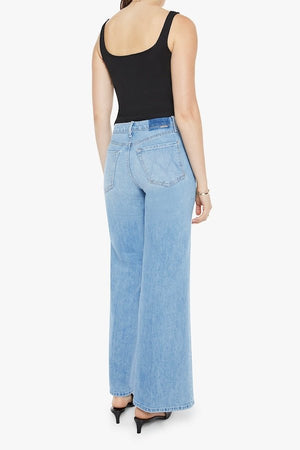 The Tomcat Roller Skimp Puzzled by MOTHER, trendy high-waisted wide-leg jeans with a button fly and light blue wash. Perfect for a relaxed, stylish look with whiskering and fading at the knees.