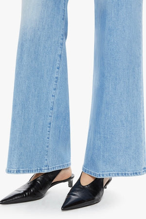 The Tomcat Roller Skimp Puzzled by MOTHER, trendy high-waisted wide-leg jeans with a button fly and light blue wash. Perfect for a relaxed, stylish look with whiskering and fading at the knees.