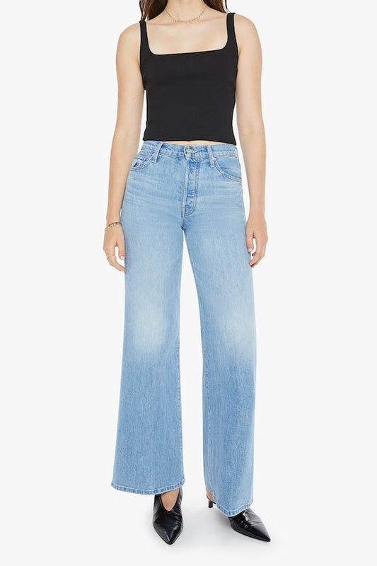 The Tomcat Roller Skimp Puzzled by MOTHER, trendy high-waisted wide-leg jeans with a button fly and light blue wash. Perfect for a relaxed, stylish look with whiskering and fading at the knees.