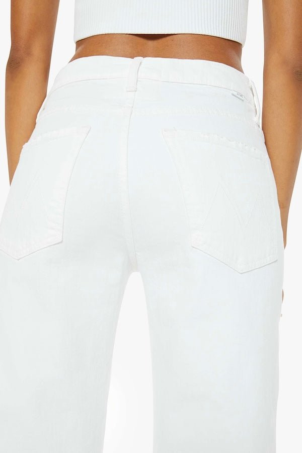 The Dodger Sneak Totally Innocent by MOTHER, trendy low-rise jeans with a slouchy, loose straight-leg fit and subtle whiskering. Perfect for casual days, offering comfort and style in a light-blue wash.