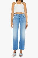 The Rambler Zip Flood Read Between The Lines by MOTHER, trendy high-waisted jeans with a wide straight leg, whiskering, and fading. Perfect for a stylish and comfortable look in a mid-blue wash.