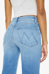 The Rambler Zip Flood Read Between The Lines by MOTHER, trendy high-waisted jeans with a wide straight leg, whiskering, and fading. Perfect for a stylish and comfortable look in a mid-blue wash.