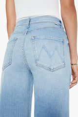 The Ditcher Roller Zip Sneak Can You Dig It? by MOTHER, trendy low-rise wide-leg jeans with a slouchy fit, dropped crotch, and light blue wash. Perfect for a relaxed, '70s-inspired look with whiskering and fading.