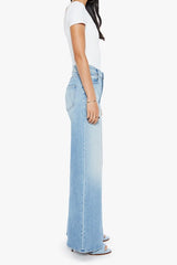 The Ditcher Roller Zip Sneak Can You Dig It? by MOTHER, trendy low-rise wide-leg jeans with a slouchy fit, dropped crotch, and light blue wash. Perfect for a relaxed, '70s-inspired look with whiskering and fading.