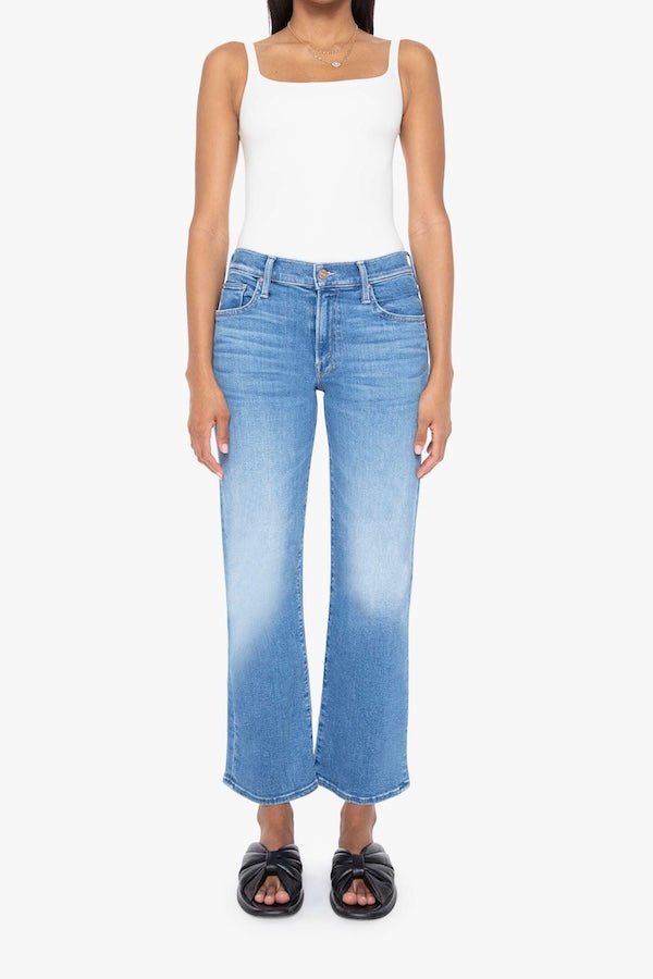 The Mid Rise Zip Rambler Ankle Out Of The Blue by MOTHER, trendy mid-rise jeans with a wide straight leg and ankle-length inseam. Perfect for a relaxed, stylish look with whiskering and fading at the knee.