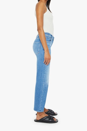 The Mid Rise Zip Rambler Ankle Out Of The Blue by MOTHER, trendy mid-rise jeans with a wide straight leg and ankle-length inseam. Perfect for a relaxed, stylish look with whiskering and fading at the knee.