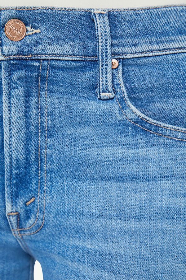 The Mid Rise Zip Rambler Ankle Out Of The Blue by MOTHER, trendy mid-rise jeans with a wide straight leg and ankle-length inseam. Perfect for a relaxed, stylish look with whiskering and fading at the knee.