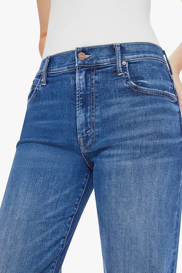 The Mid Rise Maven Sneak Over The Top by MOTHER, trendy mid-rise jeans with a relaxed wide-leg fit and subtle whiskering. Perfect for an effortlessly cool look with a vintage-inspired touch, crafted from recycled stretch denim.