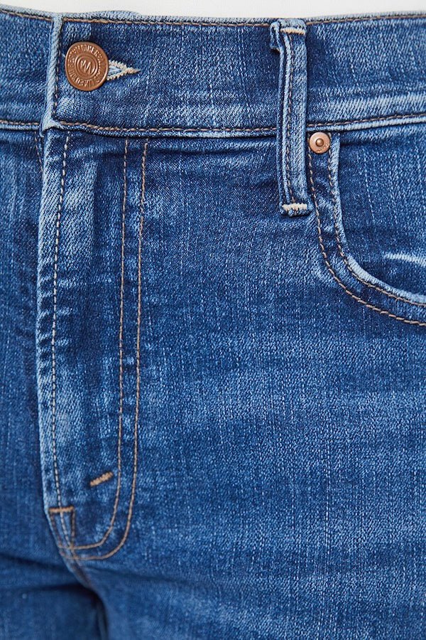 The Mid Rise Maven Sneak Over The Top by MOTHER, trendy mid-rise jeans with a relaxed wide-leg fit and subtle whiskering. Perfect for an effortlessly cool look with a vintage-inspired touch, crafted from recycled stretch denim.