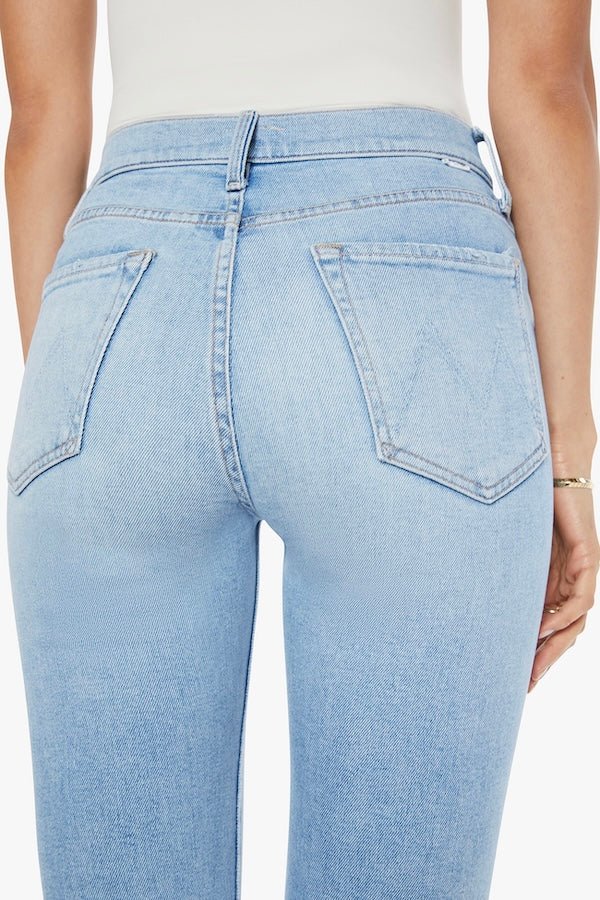 The Tripper Flood Fray Look Ma, No Hands! by MOTHER, trendy high-rise flare jeans with a button fly and frayed hem. Perfect for a stylish look with light-blue whiskering and fading.