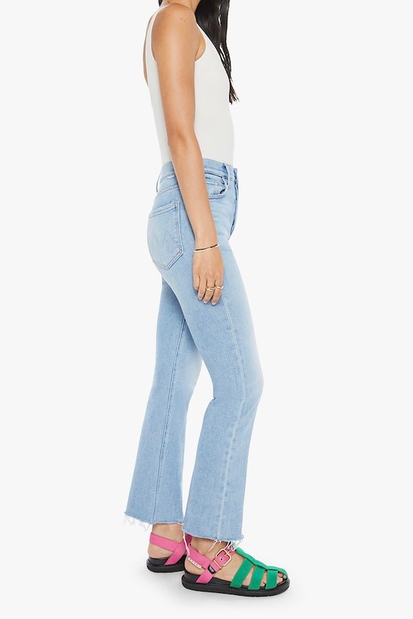 The Tripper Flood Fray Look Ma, No Hands! by MOTHER, trendy high-rise flare jeans with a button fly and frayed hem. Perfect for a stylish look with light-blue whiskering and fading.