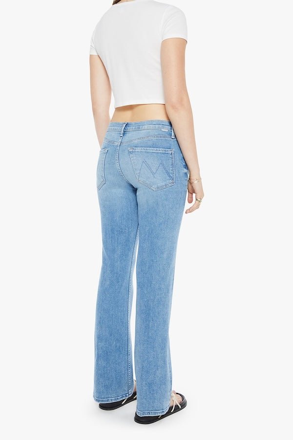 The Bookie Sneak Eye Of The Tiger by MOTHER, trendy high-rise bootcut jeans with a fitted hip and looser leg. Perfect for a relaxed, stylish look with whiskering and fading at the knees.
