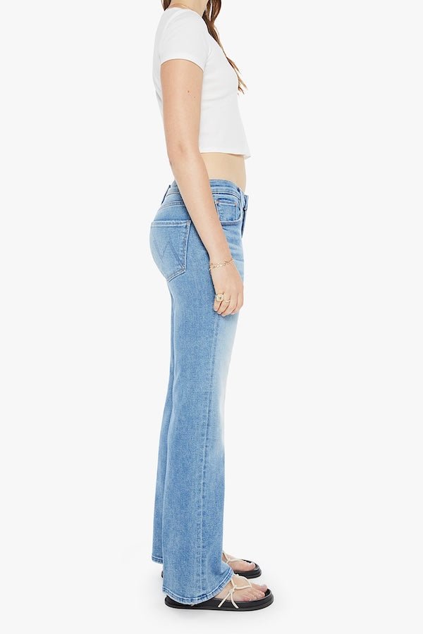 The Bookie Sneak Eye Of The Tiger by MOTHER, trendy high-rise bootcut jeans with a fitted hip and looser leg. Perfect for a relaxed, stylish look with whiskering and fading at the knees.