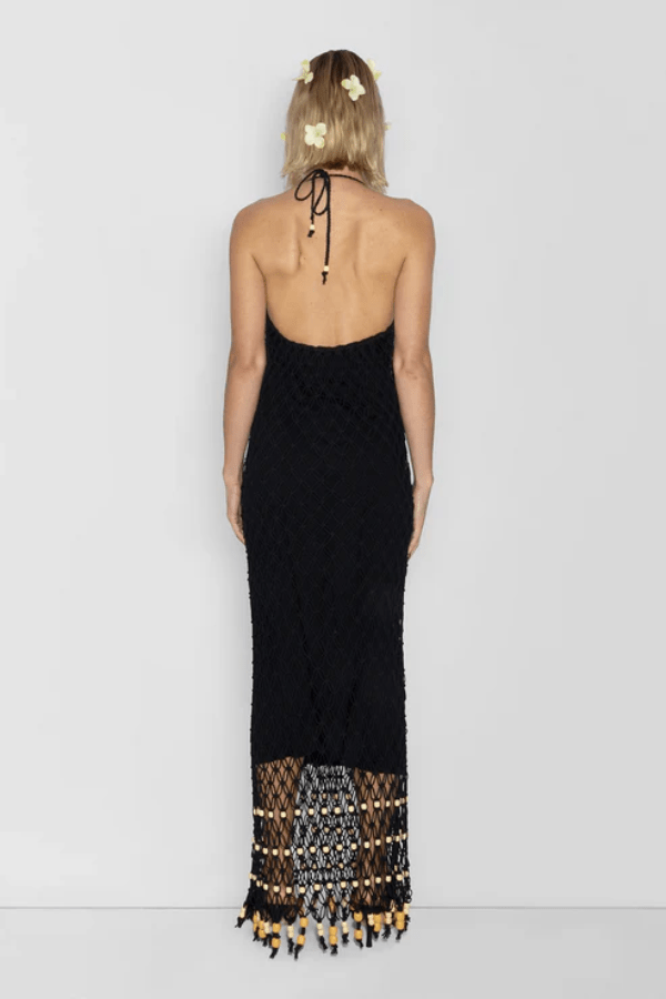 Reis Macrame Maxi Dress Noir by The Wolf Gang – Striking handmade black macrame dress with beaded hem, ideal for festivals or summer soirées.