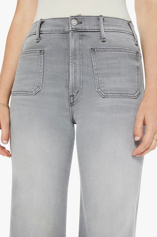 The Hustler Roller Patch Pocket Sneak Noted! by MOTHER, trendy 70s-inspired wide-leg jeans with a high rise and patch pockets. Perfect for a relaxed, stylish look in faded light grey with a clean hem.