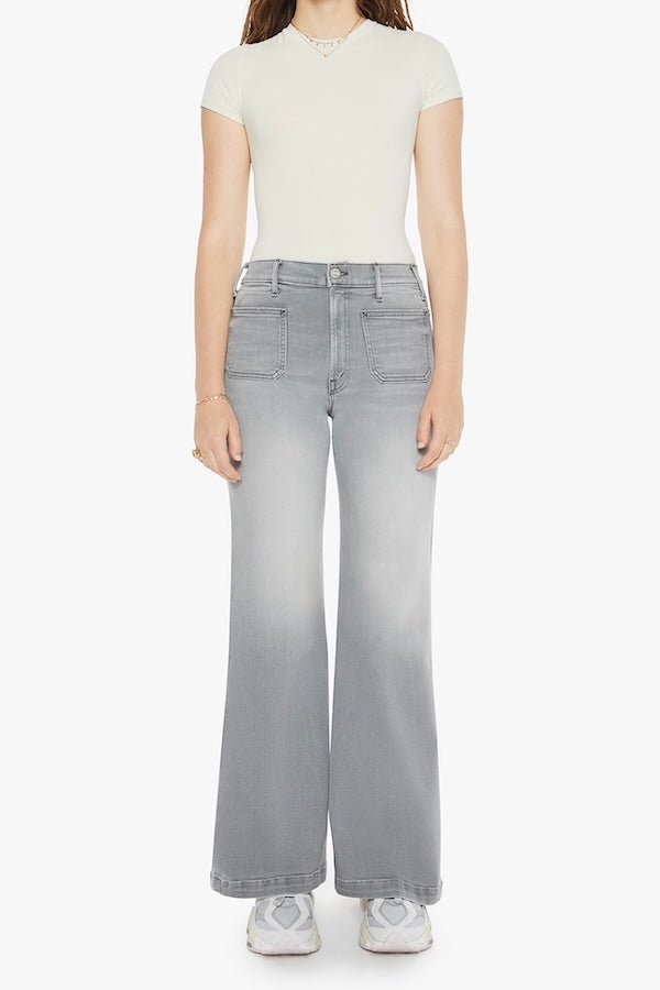 The Hustler Roller Patch Pocket Sneak Noted! by MOTHER, trendy 70s-inspired wide-leg jeans with a high rise and patch pockets. Perfect for a relaxed, stylish look in faded light grey with a clean hem.