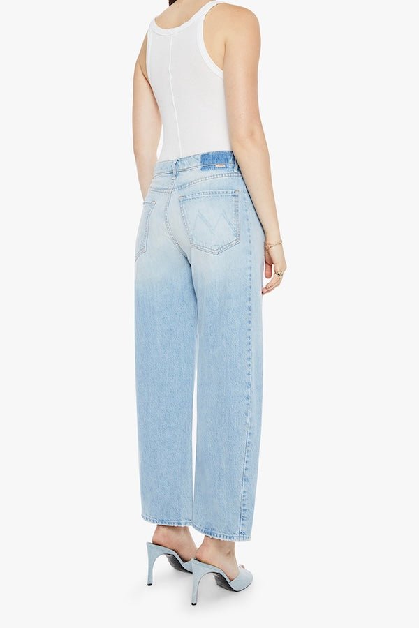 The Full Pipe Flood Back Pedal by MOTHER, trendy super high-waisted jeans with a full barrel leg and distressed details. Perfect for a relaxed, vintage-inspired look with a light blue wash.