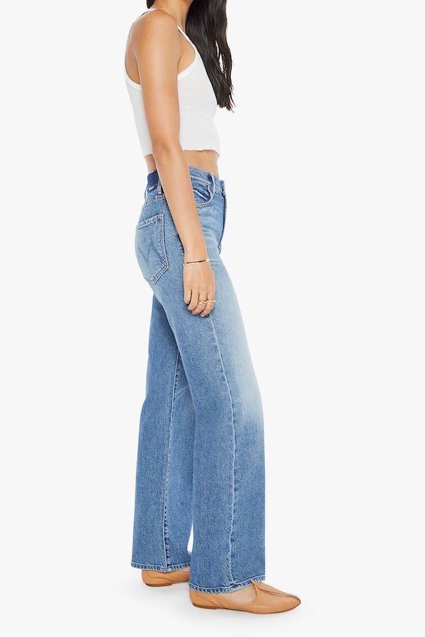 The Mid Rise Tunnel Vision Sneak I'm A Winner by MOTHER, trendy mid-rise jeans with a loose straight leg, featuring whiskering and fading at the knees. Perfect for a relaxed yet stylish look in a semi-rigid denim that softens with wear.