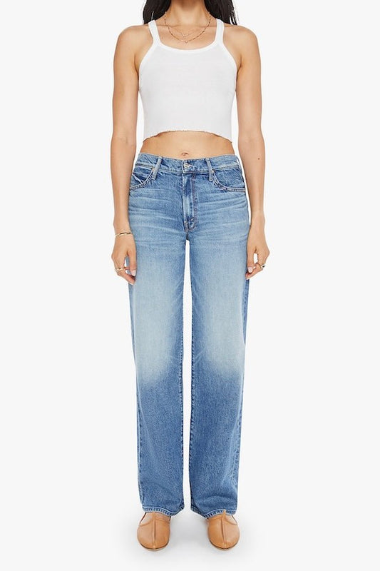 The Mid Rise Tunnel Vision Sneak I'm A Winner by MOTHER, trendy mid-rise jeans with a loose straight leg, featuring whiskering and fading at the knees. Perfect for a relaxed yet stylish look in a semi-rigid denim that softens with wear.