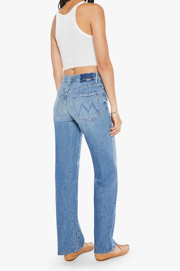 The Mid Rise Tunnel Vision Sneak I'm A Winner by MOTHER, trendy mid-rise jeans with a loose straight leg, featuring whiskering and fading at the knees. Perfect for a relaxed yet stylish look in a semi-rigid denim that softens with wear.