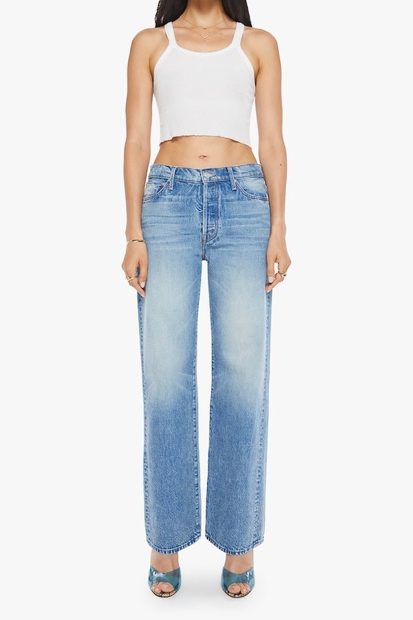 The Dodger Button Sneak Wipeout by MOTHER, trendy mid-blue jeans with a slouchy fit, loose straight leg, and a clean hem. Perfect for a relaxed look with whiskering and knee fading, made from rigid SUPERIOR denim.