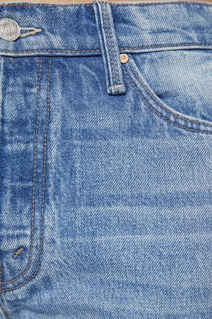 The Dodger Button Sneak Wipeout by MOTHER, trendy mid-blue jeans with a slouchy fit, loose straight leg, and a clean hem. Perfect for a relaxed look with whiskering and knee fading, made from rigid SUPERIOR denim.