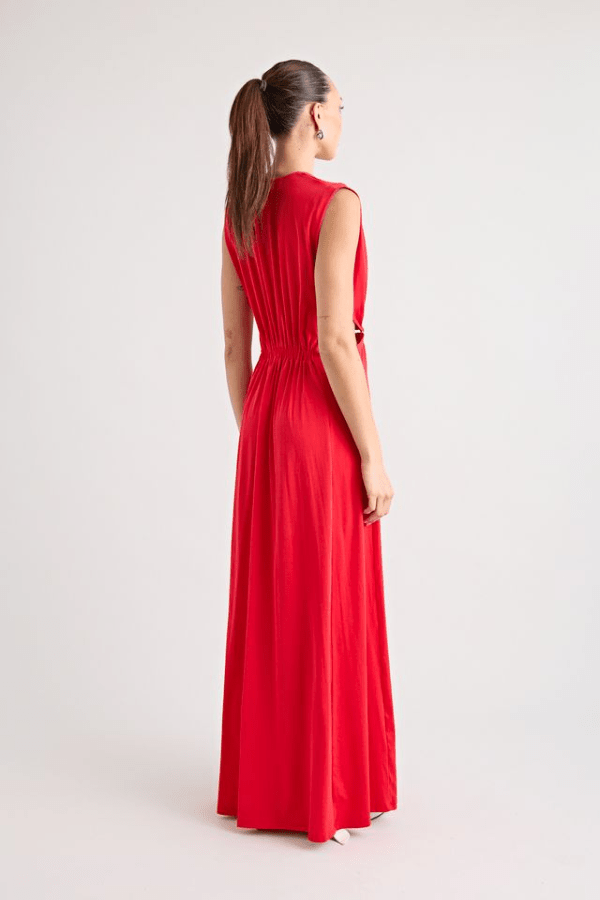 Do For Love Gown Red by Pfeiffer – A trendy low plunge maxi gown with bold hardware and thigh-high split, perfect for turning heads at special occasions.
