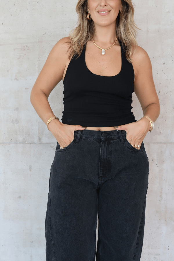 Bella Halter Tank Black by Sneaky Link – A chic, breathable cotton-spandex tank with a deep scoop neckline and open back, perfect for layering or solo wear.