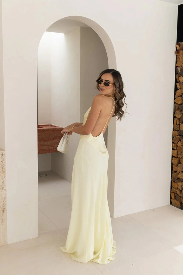 Jaz Hand V-Neck Maxi Dress in Butter by Sneaky Link, a flowing one-shoulder silhouette in soft yellow. Perfect for summer events or weddings.
