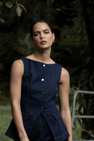 Good Vibes Top Indigo by Pasduchas – Trendy stretch denim with structured fit, gold snap studs, and mock pockets; perfect for chic, coordinated looks.