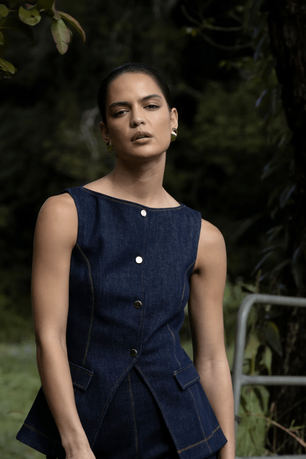 Good Vibes Top Indigo by Pasduchas – Trendy stretch denim with structured fit, gold snap studs, and mock pockets; perfect for chic, coordinated looks.