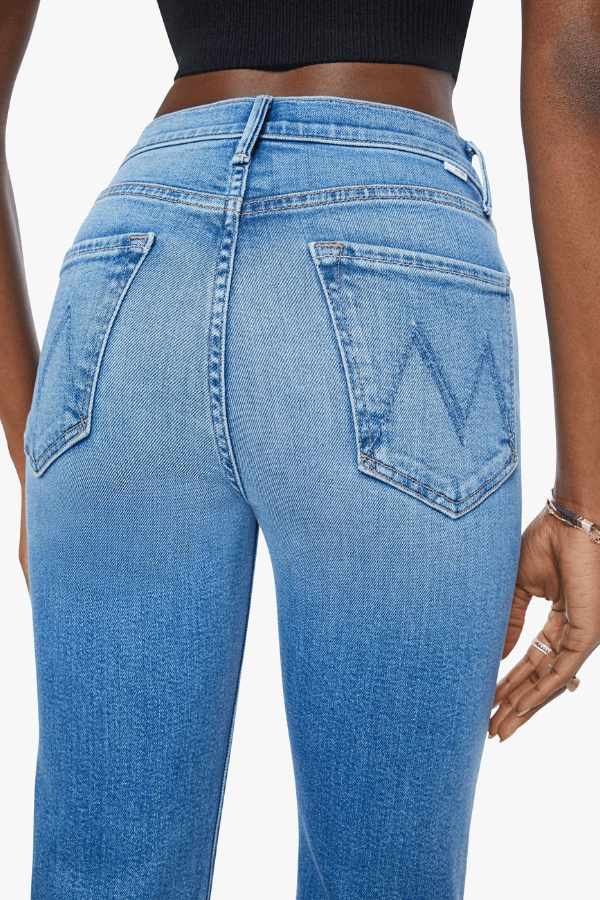 The Kick It Fan Favorite by MOTHER, trendy high-rise straight-leg jeans with a clean hem. Perfect for everyday wear with a mid-blue wash, subtle whiskering, and soft stretch denim for all-day comfort.