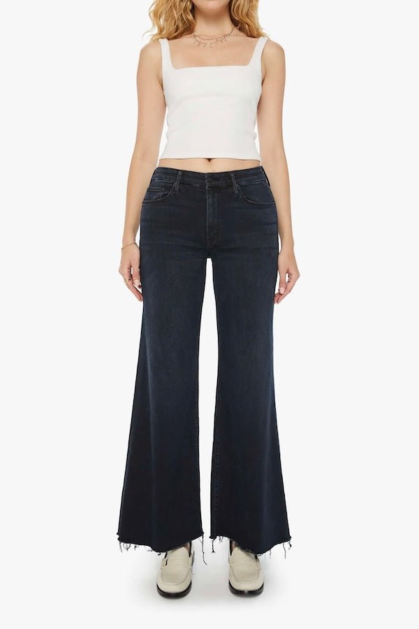 The Roller Fray Night In Venice by MOTHER, trendy high-waisted wide-leg jeans with a frayed hem and dark denim wash. Perfect for a relaxed yet stylish look with a 31-inch inseam and touch of stretch.