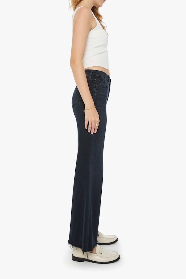 The Roller Fray Night In Venice by MOTHER, trendy high-waisted wide-leg jeans with a frayed hem and dark denim wash. Perfect for a relaxed yet stylish look with a 31-inch inseam and touch of stretch.