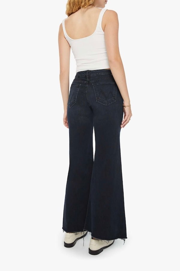 The Roller Fray Night In Venice by MOTHER, trendy high-waisted wide-leg jeans with a frayed hem and dark denim wash. Perfect for a relaxed yet stylish look with a 31-inch inseam and touch of stretch.