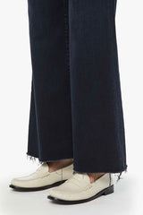 The Roller Fray Night In Venice by MOTHER, trendy high-waisted wide-leg jeans with a frayed hem and dark denim wash. Perfect for a relaxed yet stylish look with a 31-inch inseam and touch of stretch.