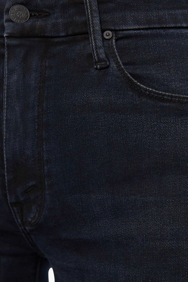 The Roller Fray Night In Venice by MOTHER, trendy high-waisted wide-leg jeans with a frayed hem and dark denim wash. Perfect for a relaxed yet stylish look with a 31-inch inseam and touch of stretch.